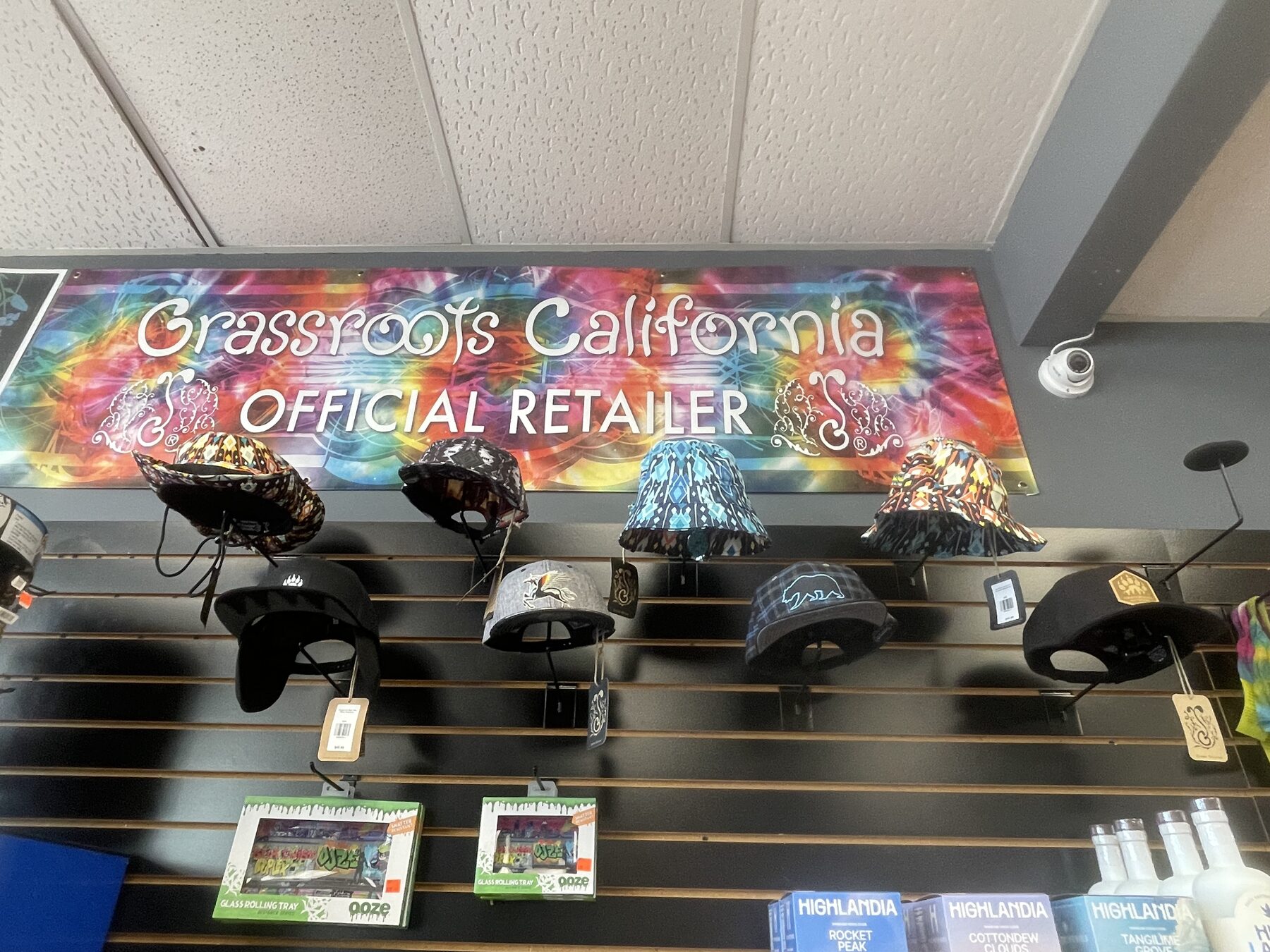 Branded hats displayed beneath colorful shop signage