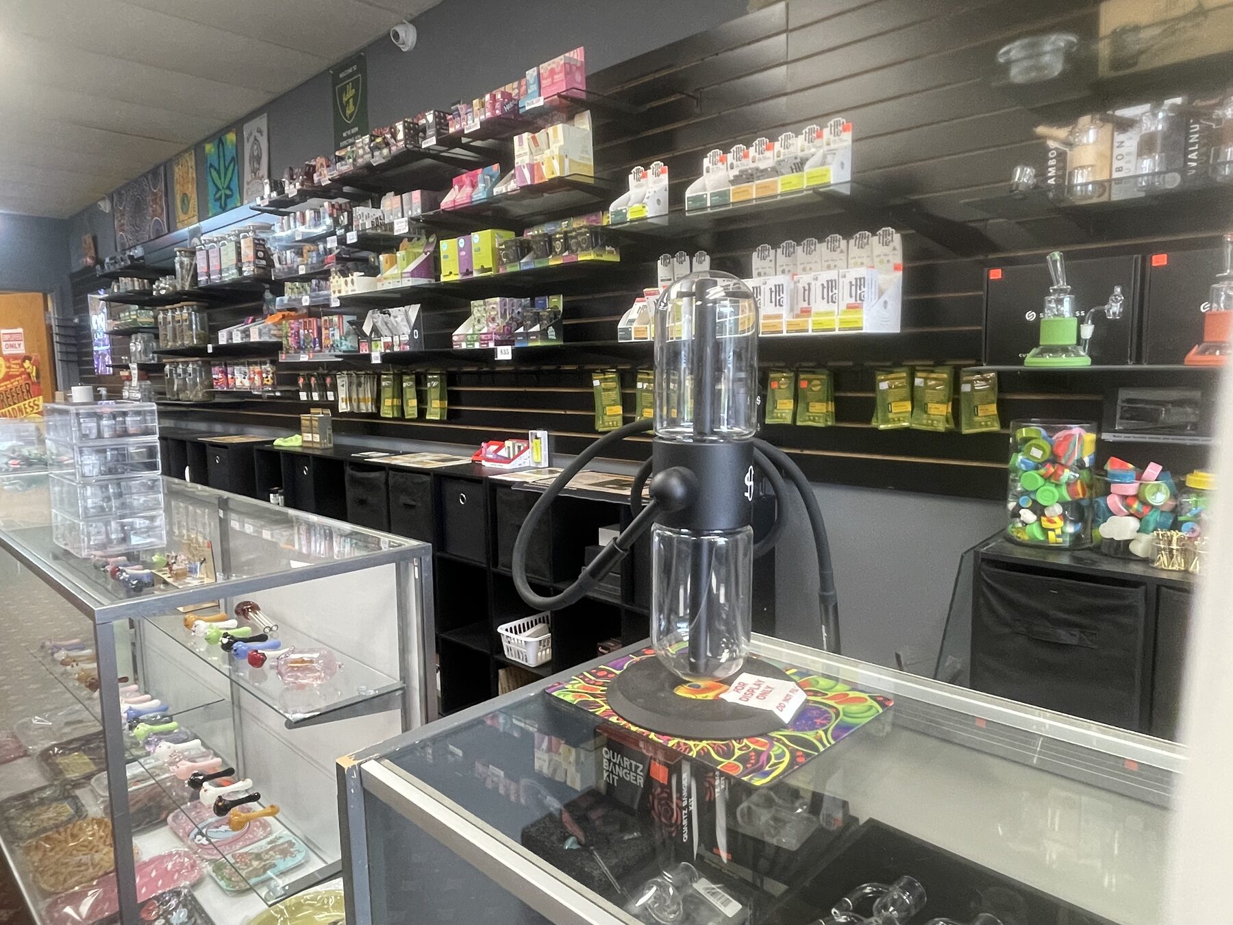 Glass display counters and stocked wall shelves inside the store