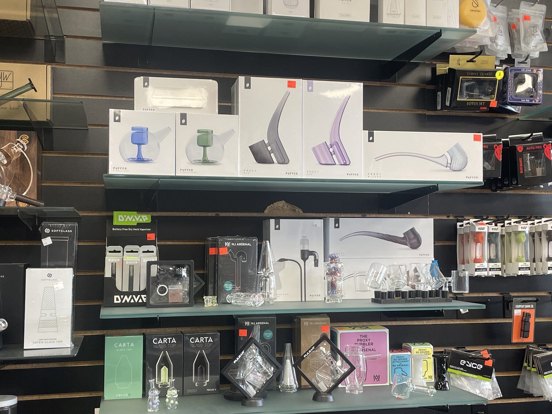 Glass accessories and boxed pieces arranged on wall shelves