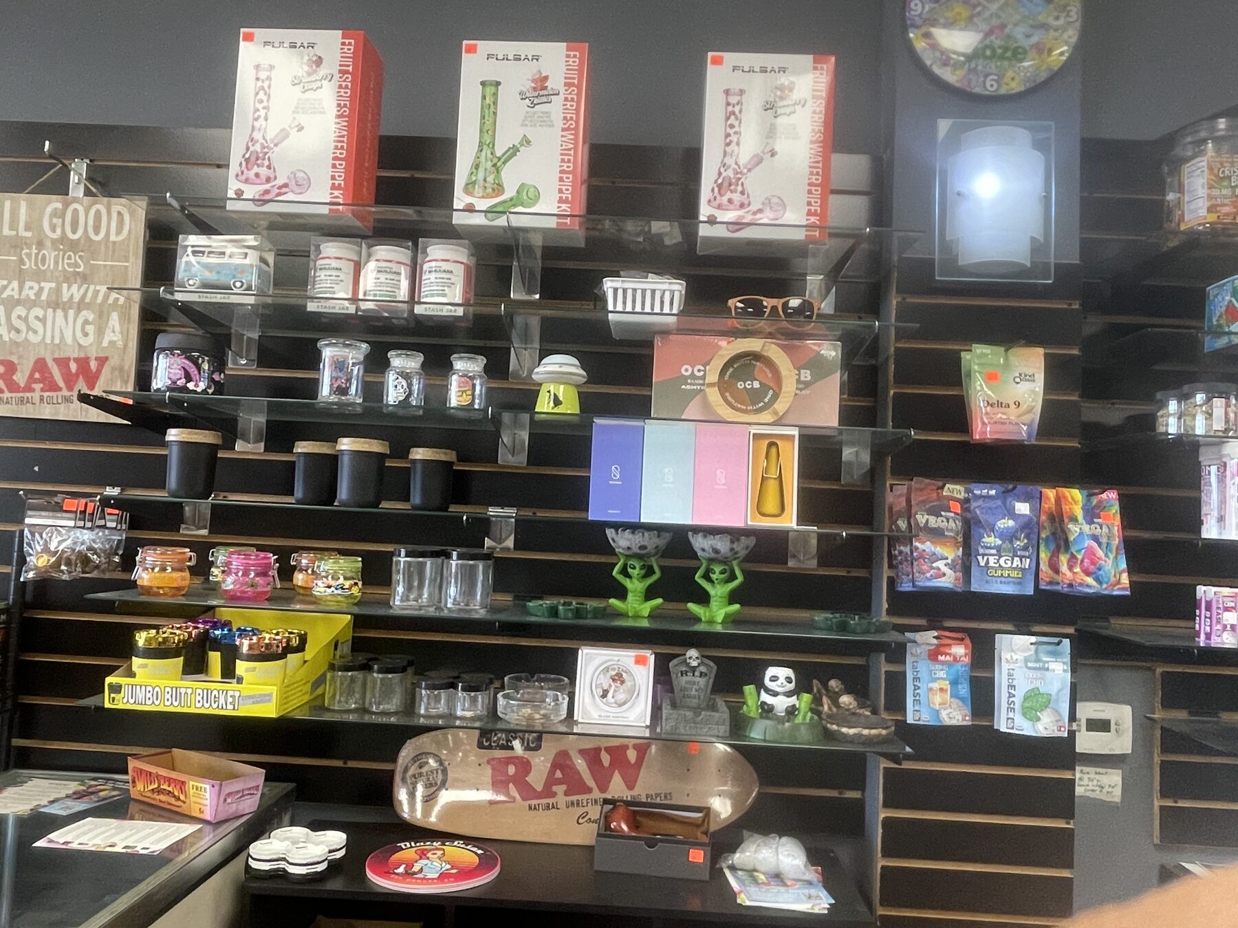 Rolling accessories, trays, and shop essentials on wall shelves